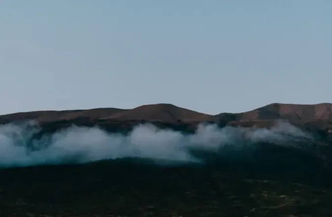 Stunning drone shot of surfers waiting for waves in the clear waters of Hawaii.