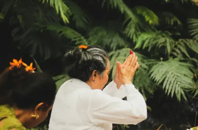Three children enjoy a sunny day playing on Waialua Beach, Hawaii, with clear skies and blue ocean waters.